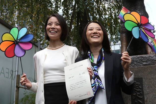 Japanese gay couple Hiroko Masuhara (R) and Koyuki Higashi display a certification paper of "partnership" issued by the Shibuya ward office after they received it in Tokyo on November 5, 2015. While the certificates are not be legally binding, the district hoped they would encourage hospitals and landlords to ensure same-sex couples receive similar treatment to married people. AFP PHOTO / Yoshikazu TSUNO (Photo credit should read YOSHIKAZU TSUNO/AFP/Getty Images)